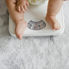 Closeup of a baby's legs on a weighing scale