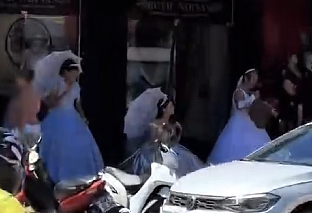 Debaixo de 40°C, mulheres vestidas de noiva viram atração em avenida de Palmas Debaixo de 40°C, mulheres vestidas de noiva viram atração em avenida de Palmas